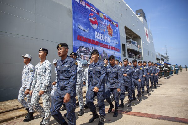 Singapore and Brunei Navy personnel march during the opening ceremony of the military non-combat exercise called ASEAN Solidarity Exercise at Batu Ampar Port on Batam island, Indonesia, Tuesday, Sept. 19, 2023. (AP Photo/Andaru Kz)