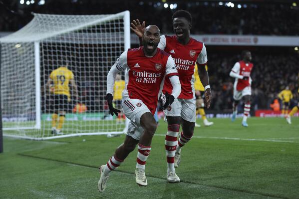 Arsenal's Alexandre Lacazette, left, celebrates after scoring his side's 2nd goal during the English Premier League soccer match between Arsenal and Wolverhampton Wanderers at the Emirates Stadium, London, Thursday, Feb. 24, 2022. (AP Photo/Ian Walton)