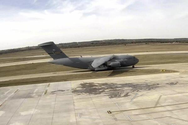 This photo provided by the City of Stillwater shows a U.S. Air Force C17 Globe Master aircraft at Stillwater Regional Airport on Sunday, Dec. 18, 2022, in Stillwater, Okla. According to city officials, the airfield was damage after the aircraft landed at the airport chartering the U.S. Air Force Women’s Basketball Team to the game against Oklahoma State University. Air Force officials say the cause of the damage is not known at this time. (City of Stillwater via AP)