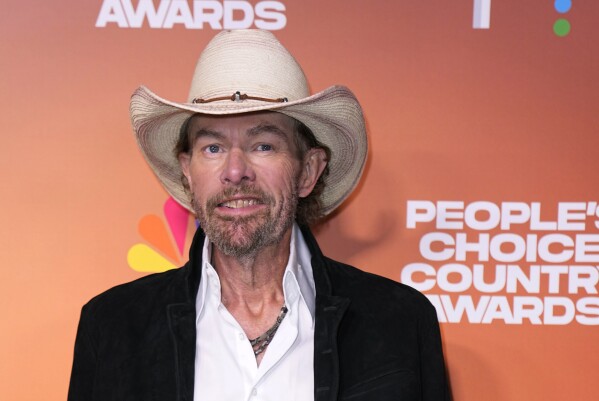 FILE - Toby Keith arrives at the People's Choice Country Awards on Thursday, Sept. 28, 2023, at The Grand Ole Opry House in Nashville, Tenn. “Beer For My Horses” singer-songwriter Toby Keith has died. He was 62. Keith passed peacefully on Monday, Feb. 5, 2024 surrounded by his family, according to a statement posted on the country singer's website. (AP Photo/George Walker IV, File)