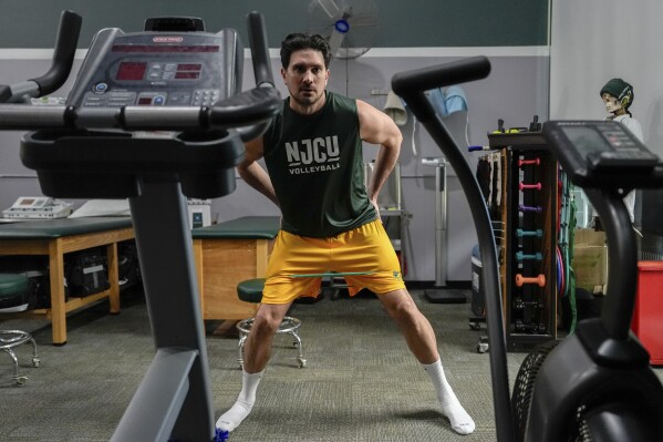 Damon LaSalle engages in rehab exercises before returning to playing volleyball following an ankle injury, Friday, Feb. 21, 2025, at New Jersey City University in Jersey City, N.J. (AP Photo/Julia Demaree Nikhinson)