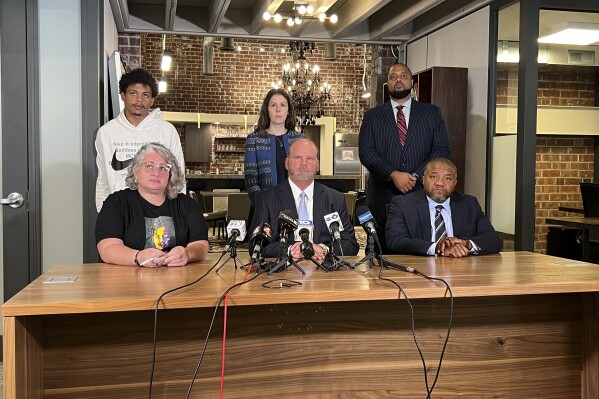 The legal team representing the family of Donovan Lewis address the media on Friday, Aug. 4, 2023, in Columbus, Ohio, after a grand jury indicted former officer Ricky Anderson in the fatal shooting of 20-year-old Donovan Lewis. From bottom left, Rebecca Duran, mother of Donovan Lewis, attorneys representing Lewis' family, Rex Elliott, and Michael Wright, and top right, Robert Gresham, and Kaela King, and Lewis' brother Tariq Stewart. (AP Photo/Patrick Orsagos)