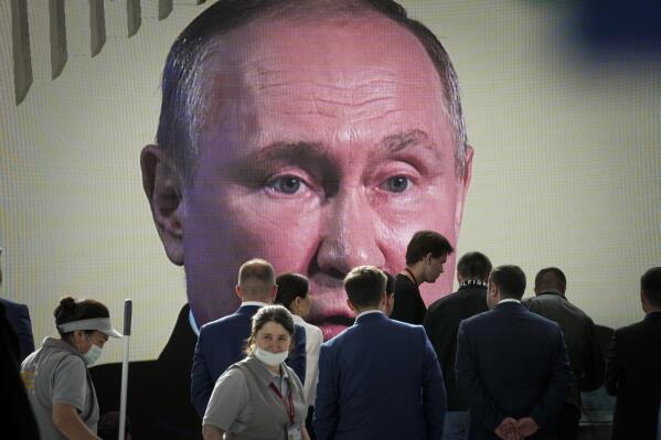 Participants watch Russian President Vladimir Putin addressing a plenary session of the St. Petersburg International Economic Forum in St.Petersburg, Russia, on Friday, June 17, 2022. Putin sent Russian forces into Ukraine on Feb. 24, 2022, and appears determined to prevail. (AP Photo, File)