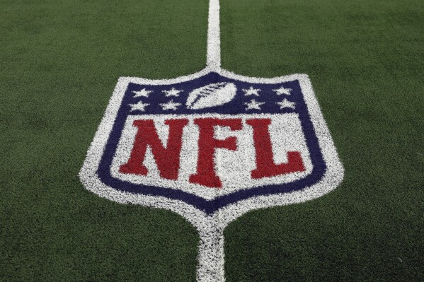 FILE - The NFL logo is shown on the field before an NFL football game between the Detroit Lions and the Dallas Cowboys, Saturday, Dec. 30, 2023, in Arlington, Texas. The NFL鈥檚 salary cap for 2024 will be $255.4 million, up a record $30.6 million from last year.(AP Photo/Matt Patterson, File)