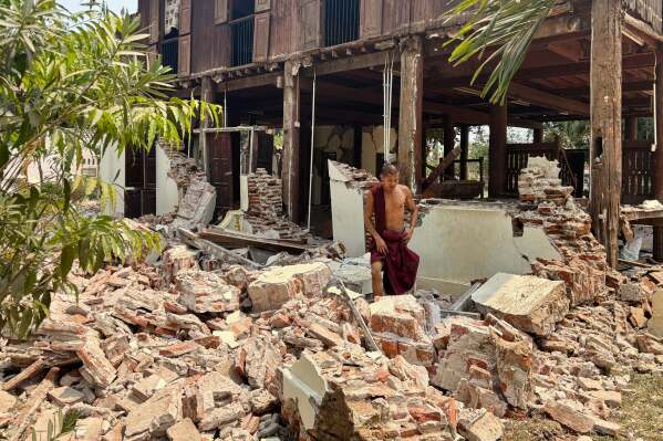 A Buddhist monk walks near a damaged building at a monastery compound after an earthquake, Friday, March 28, 2025 in Naypyitaw, Myanmar. (AP Photo/Aung Shine Oo)