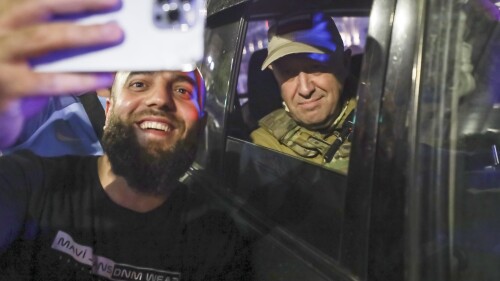 FILE - Yevgeny Prigozhin, the owner of the Wagner Group military company, right, sits inside a military vehicle posing for a selfie photo with a local civilian on a street in Rostov-on-Don, Russia, Saturday, June 24, 2023, prior to leaving an area of the headquarters of the Southern Military District. Wagner leader Yevgeny Prigozhin incited a rebellion against Russia's military leaders and marched with his troops toward Moscow but aborted his mutiny when Belarusian President Alexander Lukashenko brokered an agreement that included exile for the warlord in Belarus. (AP Photo, File)