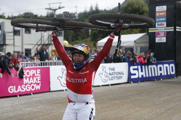 Austria's Valentina Holl celebrates after winning gold in the Women's Elite Final during day three of the 2023 UCI Cycling World Championships at the Ben Nevis Range, Fort William, Scotland, Saturday Aug. 5, 2023. (Will Matthews/PA via AP)