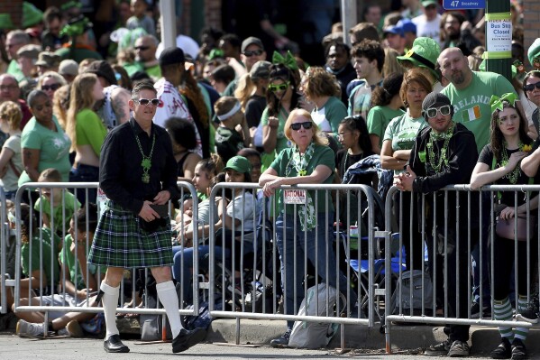 Spectators lined Broadway Boulevard at Westport Road for the St. Patrick's Day Parade, March 17, 2022, in Kansas City, Mo. Kansas City, Missouri is preparing for its annual St. Patrick's Day parade on Sunday, March 17, 2024. It will be the first big mass gathering in Kansas City since Feb. 14, when gunfire erupted as about 1 million people attended a rally celebrating the Chiefs' Super Bowl win. Organizers say extra police will be on hand Sunday, along with many other precautions. (Jill Toyoshiba/The Kansas City Star via AP)