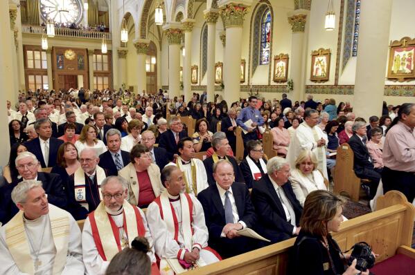 FILE - Attendees fill the Cathedral Basilica of St. Francis of Assisi in Santa Fe, N.M., during a Mass of Installation for the Rev. John C. Wester as the new archbishop of Santa Fe on June 4, 2015. Archbishop Wester is speaking about the decision to mortgage the iconic Santa Fe cathedral to meet a settlement agreement tied to church sex abuse victims. The archbishop sent letters to parishes last month informing them they would collectively need to borrow $12 million to pay for the settlements. (Clyde Mueller/Santa Fe New Mexican via AP, File)