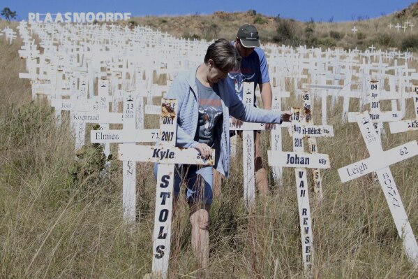 Anita de Lange, left, and her son, Hansie de Lange, tidy up at the Witkruis Monument, near Polokwane, South Africa, May 24, 2025. (AP Photo/Mogomotsi Magome)