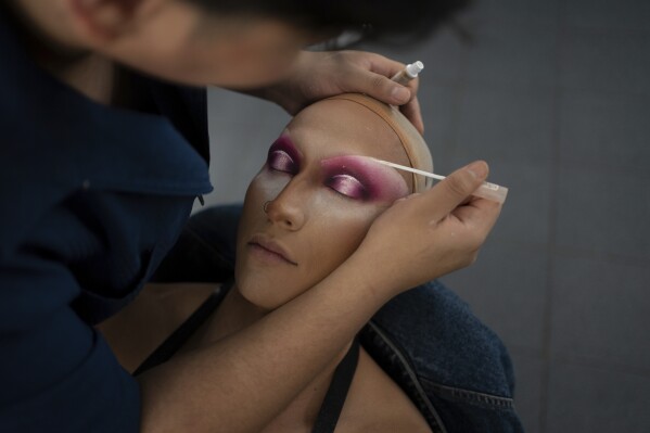A makeup-artist builds drag eyes on news anchor Guillermo Barraza as he is transformed into his drag character Amanda in preparation for the pre-taping of his program "La Verdrag", at the Canal Once studio in Mexico City, Wednesday, Oct. 11, 2023. Barraza, a journalist of 10 years, took the helm of the newscast of his public television station, Canal Once, during Mexico’s Pride celebration in June dressed in drag. (AP Photo/Aurea Del Rosario)