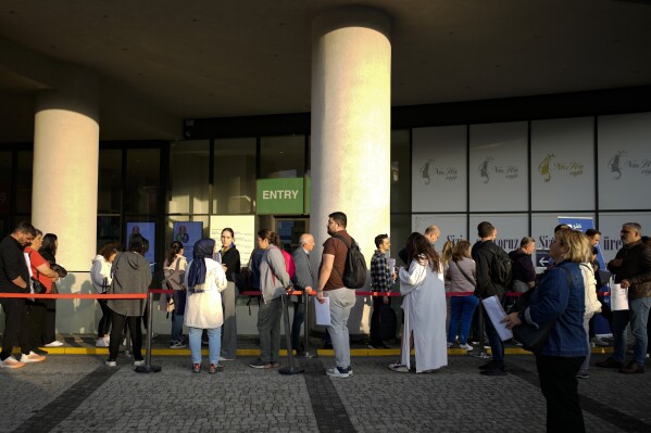 People wait for their turn at a visa application center, in Istanbul, Friday, Nov. 3, 2023. (AP Photo/Emrah Gurel)