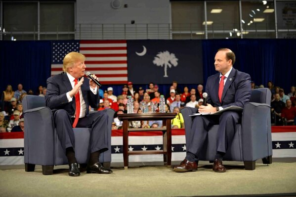 Republican presidential candidate Donald Trump speaks with South Carolina Attorney General Alan Wilson, right, during a town hall meeting in the Convocation Center on the University of South Carolina Aiken campus Saturday, Dec. 12, 2015, in Aiken, S.C. (AP Photo/Richard Shiro)