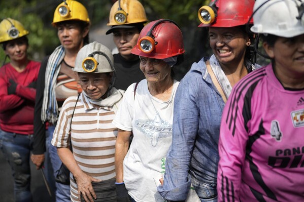 Emerald miners line uo to enter the tunnels of an informal mine near the town of Coscuez, Colombia, Thursday, Feb. 29, 2024. (AP Photo/Fernando Vergara)