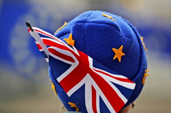 
              A protestor wears a European hat and a Union Jack flag opposite the Houses of Parliament as Pro-European demonstrators protest in London, Monday, Jan. 14, 2019. Britain's Prime Minister Theresa May is struggling to win support for her Brexit deal in Parliament. Lawmakers are due to vote on the agreement Tuesday, and all signs suggest they will reject it, adding uncertainty to Brexit less than three months before Britain is due to leave the EU on March 29. (AP Photo/Frank Augstein)
            