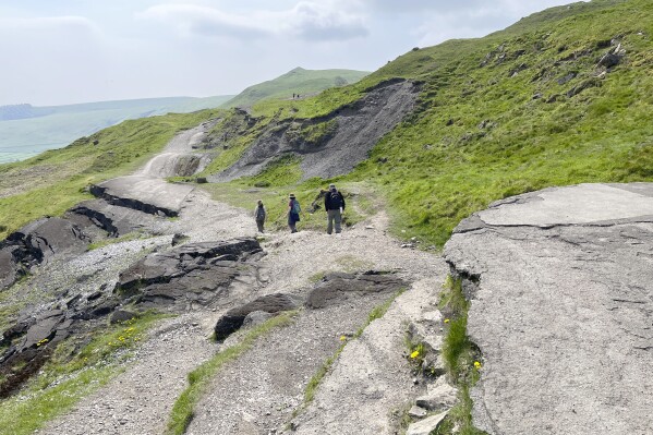 Hikers make their way along Mam Tor, a 517 meters high (1,696 feet) hill in England’s Peak District National Park on May 8, 2024. (Steve Wartenberg via AP)