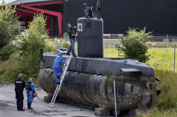 FILE - Police technicians board Peter Madsen's submarine UC3 Nautilus on a pier in Copenhagen harbour, Denmark, on Aug. 13, 2017. The rights of a self-taught Danish engineer who was convicted of murdering a Swedish journalist in 2017 on his homemade submarine, have not been violated, a Danish court said Thursday, Nov. 30, 2023. The following year, Peter Madsen was sentenced to life in prison for killing Kim Wall, a 30-year-old freelance reporter, after bringing her aboard his submarine with the promise of an interview. (Jacob Ehrbahn/Ritzau Foto, File via AP)