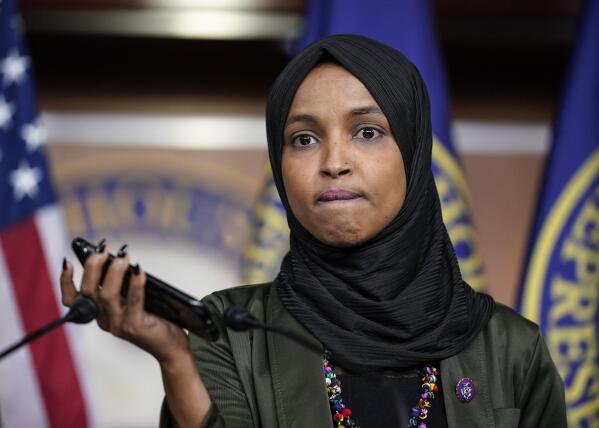 Rep. Ilhan Omar, D-Minn., plays a recording of a death threat left on her voicemail in the wake of anti-Islamic comments made last week by Rep. Lauren Boebert, R-Colo., who likened Omar to a bomb-carrying terrorist, during a news conference at the Capitol in Washington, Tuesday, Nov. 30, 2021. (AP Photo/J. Scott Applewhite)