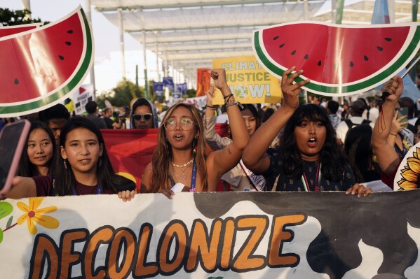 Mitzi Jonelle Tan, of the Philippines, center, and activists demonstrate for climate justice and a ceasefire in the Israel-Hamas war at the COP28 U.N. Climate Summit, Saturday, Dec. 9, 2023, in Dubai, United Arab Emirates. (AP Photo/Rafiq Maqbool, File)