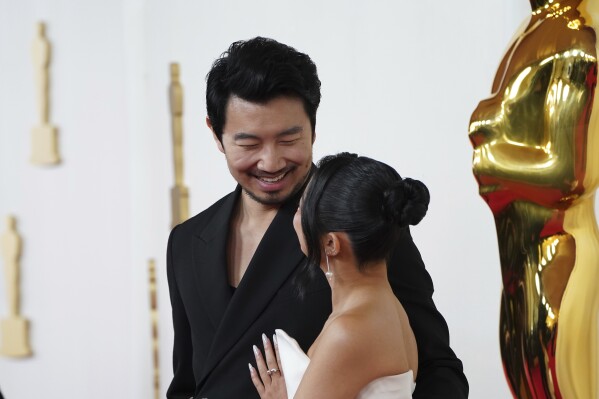 Simu Liu, left, and Allison Hsu arrive at the Oscars on Sunday, March 10, 2024, at the Dolby Theatre in Los Angeles. (Photo by Jordan Strauss/Invision/AP)