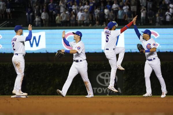 From left to right, Chicago Cubs' Nico Hoerner, Seiya Suzuki, Christopher Morel and Rafael Ortega celebrate their win over the Pittsburgh Pirates in a baseball game Monday, July 25, 2022, in Chicago. (AP Photo/Charles Rex Arbogast)