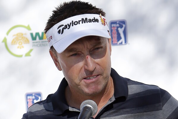 FILE - Robert Allenby, of Australia, talks to the media at a practice round for the Phoenix Open golf tournament, Tuesday, Jan. 27, 2015, in Scottsdale, Ariz. Scottie Scheffler's arrest hours before his second-round tee time at the PGA Championship in Louisville will go down as one of the most shocking in professional golf history. It certainly wasn't the first, though. Allenby was arrested outside of a casino in Rock Island, Illinois, hours after he missed the cut in the 2016 John Deere Classic. (AP Photo/Rick Scuteri, File)