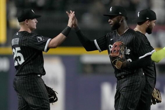 Chicago White Sox's Andrew Vaughn (25) and Luis Robert Jr. celebrate the team's 5-1 win over the New York Yankees in a baseball game Monday, Aug. 7, 2023, in Chicago. (AP Photo/Charles Rex Arbogast)