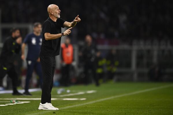 AC Milan coach Stefano Pioli gives instructions during the Serie A soccer match between Torino and AC Milan at the Turin Olympic stadium, Italy Sunday, Oct. 30, 2022. (Fabio Ferrari/LaPresse via AP)