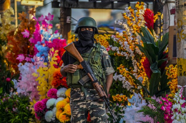 An Indian paramilitary soldier guards at a busy market in Srinagar, Indian controlled Kashmir, Tuesday, Aug 1, 2023. India’s top court Wednesday began hearing a clutch of petitions challenging the constitutionality of the legislation passed by Prime Minister Narendra Modi’s government in 2019 that stripped disputed Jammu and Kashmir’s statehood, scrapped its separate constitution and removed inherited protections on land and jobs. (AP Photo/Mukhtar Khan)