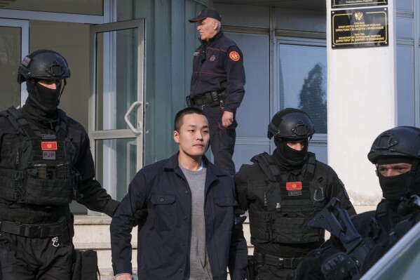 Montenegrin police officers escort South Korean citizen, Terraform Labs founder Do Kwon in Montenegro's capital Podgorica, Saturday, March 23, 2024. Do Kwon was transferred on Saturday from prison, where he had served a 4-month sentence for using a fake passport, to a facility for foreigners pending his announced extradition to his native South Korea. (AP Photo/Risto Bozovic)