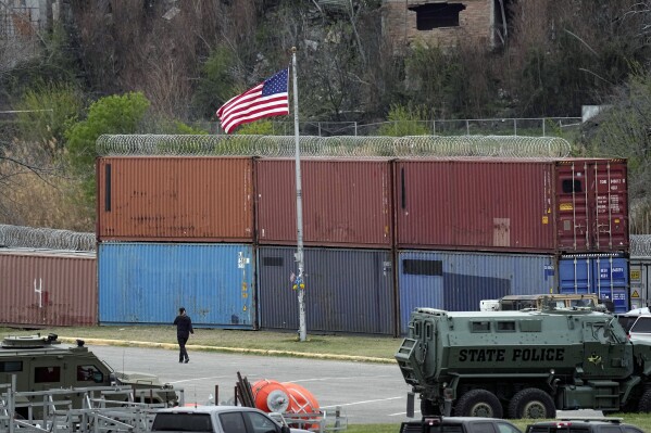 Box cars and concertina wire block the shores along the Rio Grande in Shelby Park, Wednesday, Feb. 28, 2024, in Eagle Pass, Texas. Republican presidential candidate former President Donald Trump is scheduled to visit the area Thursday. (AP Photo/Eric Gay)