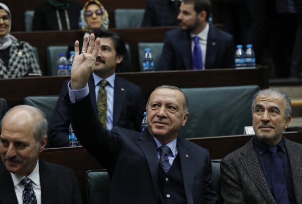 
              Turkey's President Recep Tayyip Erdogan waves as he arrives to deliver a speech to MPs of his ruling Justice and Development Party (AKP) at the parliament in Ankara, Turkey, Tuesday, Jan. 8, 2019. (AP Photo/Burhan Ozbilici)
            