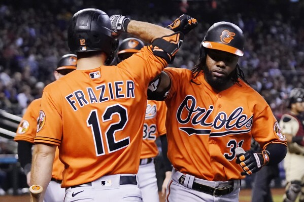 Baltimore Orioles' Cedric Mullins (31) celebrates after his three-run home run against the Arizona Diamondbacks with teammate Adam Frazier (12) during the fourth inning of a baseball game Saturday, Sept. 2, 2023, in Phoenix. (AP Photo/Ross D. Franklin)