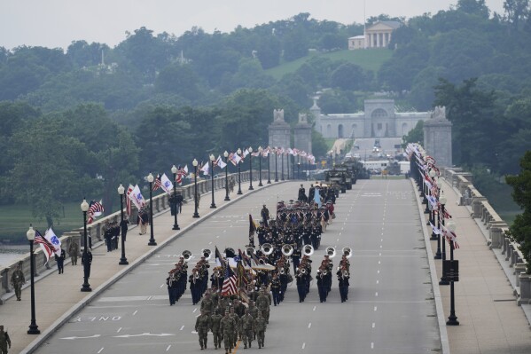 A military parade commemorating the Army's 250th anniversary, coinciding with President Donald Trump's 79th birthday, crosses over the Potomac River from Virginia into Washington, Saturday, June 14, 2025, in Washington. Robert E. Lee's home, Arlington House, stands at Arlington National Cemetery in Arlington, Va., rear. (AP Photo/Stephanie Scarbrough)