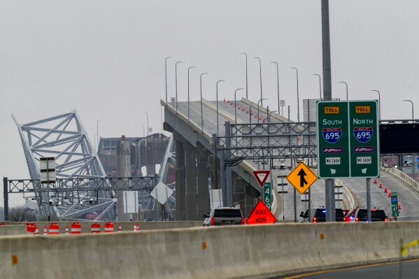 Shown is the wreckage of Francis Scott Key Bridge as seen from Dundalk, Md., on Wednesday, March 27, 2024, Recovery efforts resumed Wednesday for the construction workers who are presumed dead after the cargo ship hit a pillar of the bridge, causing the structure to collapse. (AP Photo/Matt Rourke)