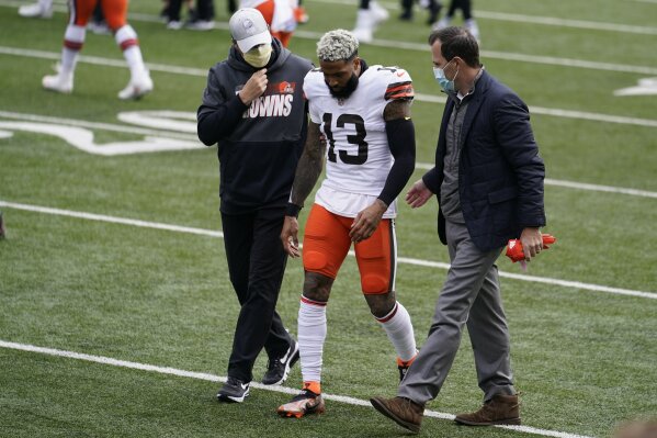 CORRECTS TO FIRST HALF - Cleveland Browns wide receiver Odell Beckham Jr. (13) is helped off the field in the first half of an NFL football game against the Cincinnati Bengals, Sunday, Oct. 25, 2020, in Cincinnati. (AP Photo/Michael Conroy)