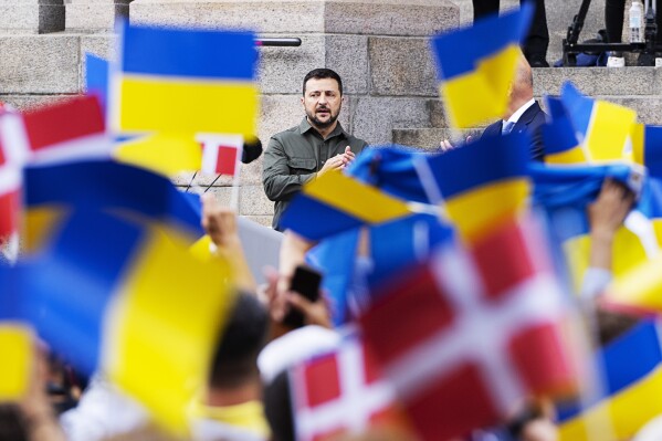 Ukrainian President Volodymyr Zelenskyy addresses the Danish people from the steps of Christiansborg palace, the seat of Danish Parliament, in Copenhagen, Denmark, Monday, Aug. 21, 2023. Thousands of people had gathered in the palace courtyard to hear his speech, many waving Ukrainian or Danish flags. (Claus Bech/Ritzau Scanpix via AP)