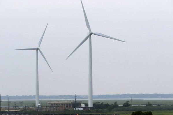 Land-based windmills in Atlantic City turn on Thursday, July 20, 2023. On Thursday, July 27, two groups opposed to offshore wind projects sued New Jersey and the Danish offshore wind energy developer Orsted seeking to overturn the tax break. (AP Photo/Wayne Parry)