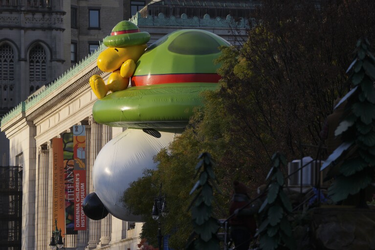 The Beagle Scout Snoopy balloon sits poised for the start of the Macy's Thanksgiving Day parade near the New York Historical Society Museum, Thursday, Nov. 23, 2023, in New York. (AP Photo/Jeenah Moon)