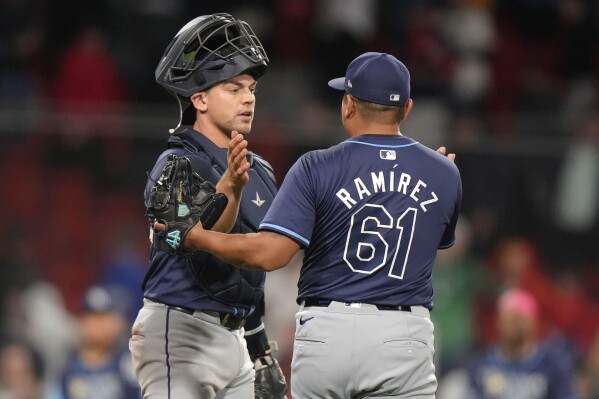 Tampa Bay Rays' Ben Rortvedt, left, celebrates with Erasmo Ramírez, right, after they defeated the Boston Red Sox in a baseball game Thursday, May 16, 2024, in Boston. (Ǻ Photo/Steven Senne)