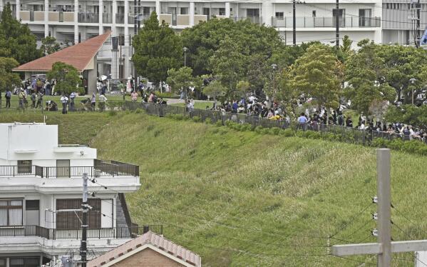 People evacuate to higher ground after a tsunami warning following a powerful earthquake in Naha, Okinawa prefecture, Japan, Wednesday, April 3, 2024. A powerful earthquake rocked the entire island of Taiwan early Wednesday, collapsing buildings in a southern city and creating a tsunami that washed ashore on southern Japanese islands.(Kyodo News via AP)
