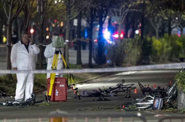 
              Bicycles and debris lay on a bike path at the crime scene where investigators work after a motorist earlier in the day drove onto the path near the World Trade Center memorial, striking and killing several people Tuesday, Oct. 31, 2017. (AP Photo/Craig Ruttle)
            