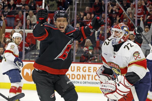 Carolina Hurricanes' Evgeny Kuznetsov (92) celebrates a goal by Martin Necas against Florida Panthers goaltender Sergei Bobrovsky (72) during the second period of an NHL hockey game in Raleigh, N.C., Thursday, March 14, 2024. (AP Photo/Karl B DeBlaker)