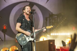 FILE - Eddie Vedder of Pearl Jam performs at Bonnaroo Music and Arts Festival in Manchester, Tenn. on June 11, 2016. Pearl Jam has encouraged fans to vote and asks them to take a pledge to try and mail-in their ballots. Vedder posted step-by-step photos on his Instagram page on how to vote by mail. (Photo by Amy Harris/Invision/AP, File)