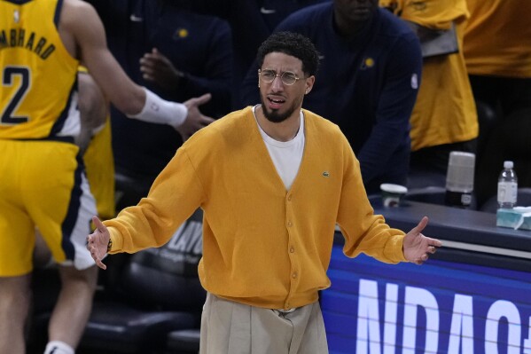 Injured Indiana Pacers guard Tyrese Haliburton reacts during the first half of Game 3 of the NBA Eastern Conference basketball finals against the Boston Celtics, Saturday, May 25, 2024, in Indianapolis. (AP Photo/Darron Cummings)