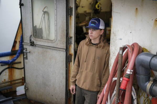 Lane Bolich, captain of the Harmony, poses for a portrait, Saturday, June 24, 2023, in Kodiak, Alaska. After working as a deckhand for two years, he took the wheel as captain this year at just 20 years old. (AP Photo/Joshua A. Bickel)