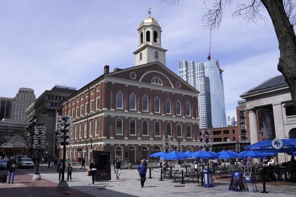FILE - Visitors pass Faneuil Hall, April 5, 2022, in Boston. A Boston city councilor is expected to introduce a resolution Wednesday, Oct. 25, 2023, to hold a hearing on renaming Faneuil Hall, a popular tourist site which has ties to slavery. (AP Photo/Charles Krupa, File)