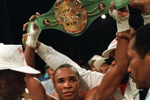 FILE — Sugar Ray Leonard, U.S.A., holds the middleweight championship belt above his head after defeating Marvin Hagler in a split decision to win the title in Las Vegas, Nev., April 6, 1987. A World Boxing Council championship belt belonging to former South African President Nelson Mandela has been stolen from a museum in Soweto. The belt was given to Mandela by American boxing legend Leonard during one of his visits to South Africa. (AP Photo/Lennox McLendon/File)