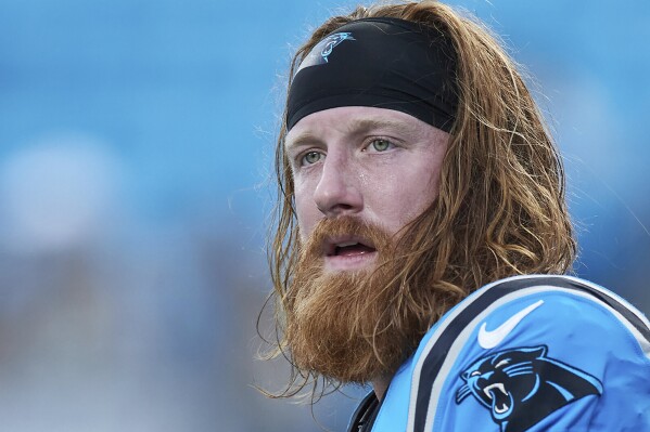 FILE - Carolina Panthers tight end Hayden Hurst (81) warms up prior to an NFL preseason football game against the Detroit Lions, Friday, Aug. 25, 2023, in Charlotte, N.C. Hurst had Tommy John surgery after his eighth grade school year. He was a high-level baseball prospect and eventually pitched in the Pittsburgh Pirates organization for a couple seasons. (AP Photo/Brian Westerholt, File)