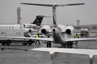 FILE - Planes are parked at a private jet terminal at Harry Reid International Airport ahead of the Super Bowl, Feb. 1, 2024, in Las Vegas. President Joe Biden is proposing a huge increase in fuel taxes for private jets, which his administration is pitching as a fairness issue compared with airline passengers, who pay special taxes on every ticket. The proposal was included in a $109.3 billion budget request for the U.S. Department of Transportation, which was released Monday, March 11, 2024. (AP Photo/John Locher, File)